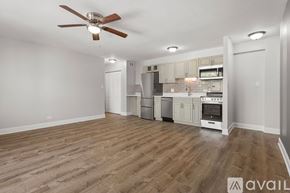 Chicago apartment for rent - A spacious kitchen with a fan and wooden flooring.