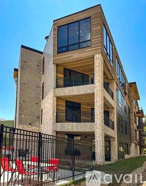 Winter Park condo for rent - A modern house with a black fence and red chairs in front.