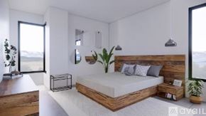 Winter Park condo for rent - A bedroom with a bed, nightstand, and a plant.