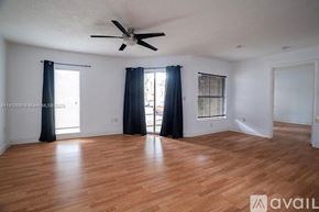 West Palm Beach condo for rent - A room with wooden flooring and a ceiling fan.