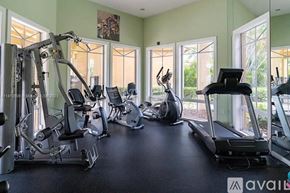 West Palm Beach condo for rent - A gym with a variety of equipment including treadmills, elliptical machines, and weight machines.