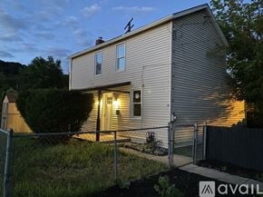 Monongahela house for rent - A house with a fence and a sign that says "AVAIL" in front of it.