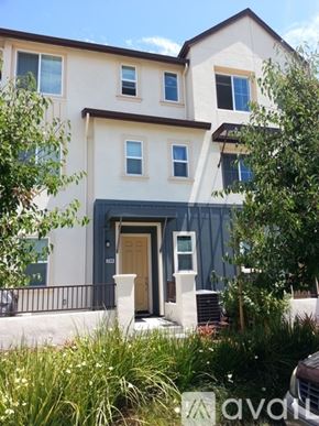 Hayward apartment for rent - A two-story house with a brown door and windows.