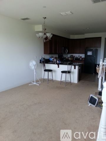 Hayward apartment for rent - A kitchen with a fan and a dining table.