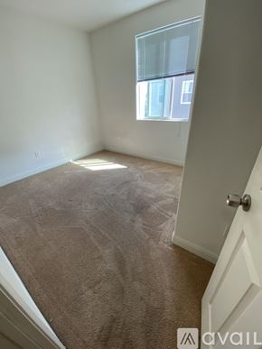 Hayward apartment for rent - A room with a carpeted floor and a door leading to another room.
