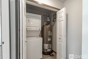 Rapid City apartment for rent - A small, white, built-in refrigerator and freezer are in a kitchen pantry.