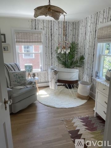 Sewickley house for rent - A living room with a white couch and a wooden floor.
