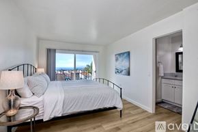 Carlsbad apartment for rent - A bedroom with a large bed and a balcony overlooking the water.