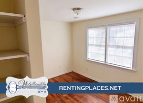 Augusta apartment for rent - A room with a wooden floor and a window with blinds.