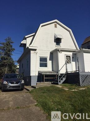 Belle Vernon house for rent - A white house with a car parked in front.
