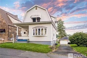 Belle Vernon house for rent - A house with a porch and a covered walkway leading to the front door.