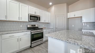 Sierra Vista house for rent - A kitchen with white cabinets and a granite countertop.