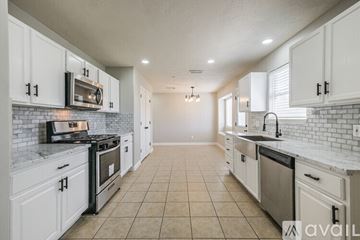Houston apartment for rent - A kitchen with white cabinets and appliances.