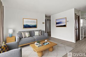 Yorktown apartment for rent - A living room with a grey couch, a wooden coffee table, and two framed pictures on the wall.
