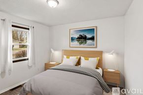 Yorktown apartment for rent - A bedroom with a bed, nightstands, and a painting of a lake.