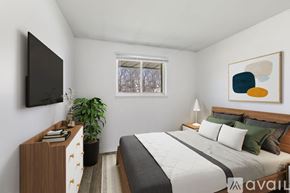 Yorktown apartment for rent - A bedroom with a bed, nightstand, and a television.
