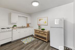 Yorktown apartment for rent - A kitchen with white appliances and wooden flooring.