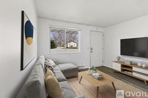 Yorktown apartment for rent - A living room with a grey couch, a coffee table, and a painting on the wall.