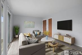 Elwood apartment for rent - A living room with a grey couch, a wooden coffee table, and a flat-screen TV mounted on the wall.