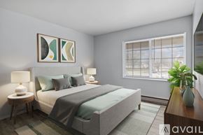 Elwood apartment for rent - A bedroom with a large bed, two lamps, and a painting on the wall.