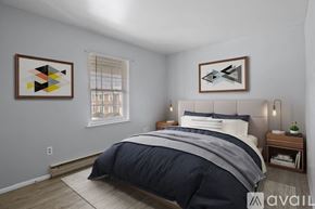 Elwood apartment for rent - A bedroom with a large bed and two abstract art pieces on the wall.