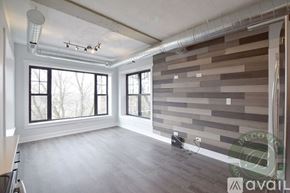 Chicago apartment for rent - A room with a wall made of wooden planks and a window.