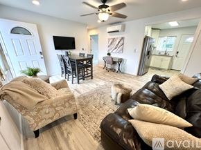 Kailua house for rent - A living room with a couch, chair, and a dog.