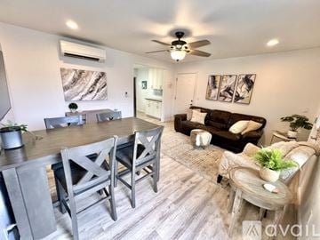Kailua house for rent - A living room with a brown couch and a wooden table.