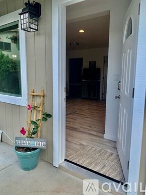 Kailua house for rent - A doorway with a plant and a sign that says "welcome".