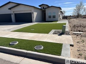 Socorro apartment for rent - A house with a grey garage door and a white house with a grey roof.