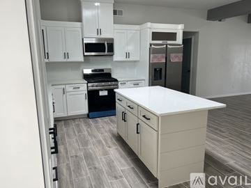 Socorro apartment for rent - A kitchen with white cabinets and a white island.