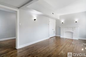 Chicago apartment for rent - A room with a fireplace and wooden floors.