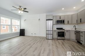 Chicago apartment for rent - A kitchen with a refrigerator, microwave, oven, and sink.