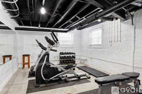 Chicago apartment for rent - A gym with a rowing machine, dumbbells, and a bench.