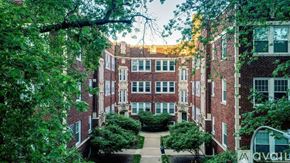 Chicago apartment for rent - A large brick building with a green lawn in front.