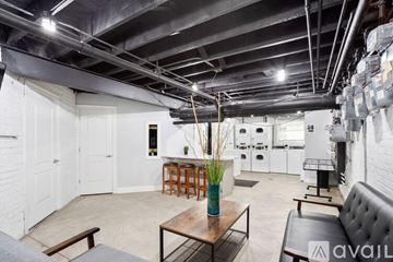 Chicago apartment for rent - A room with a table and chairs in the foreground and a kitchen in the background.
