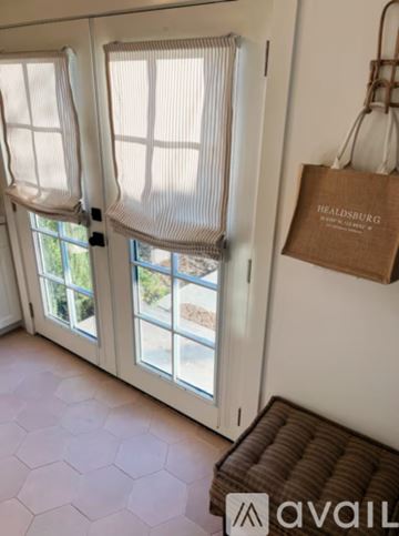 Healdsburg apartment for rent - A living room with a white couch, a wooden coffee table, and a television on a cabinet.