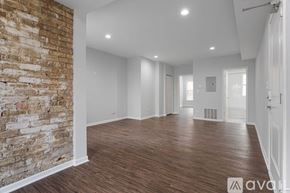 Chicago apartment for rent - A large empty room with wooden floors and white walls.