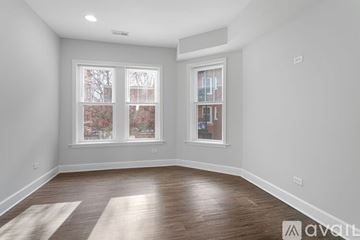 Chicago apartment for rent - A kitchen with wooden cabinets and black appliances.