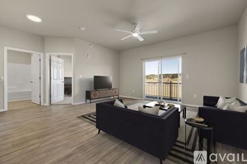 Piedmont apartment for rent - A spacious living room with a large couch and a television.
