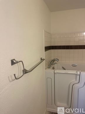 Casa Grande house for rent - A white bathroom with a white tub and a white towel rack.