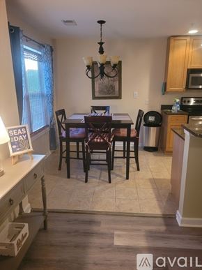 Southport condo for rent - A kitchen with a dining table and chairs.