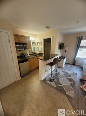 Southport condo for rent - A kitchen with a bar stool and a counter.