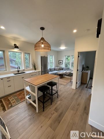 Bend apartment for rent - A kitchen with a table and chairs in the middle of the room.