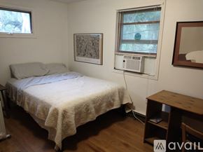Brooktondale apartment for rent - A kitchen with wooden cabinets and a stove top oven.