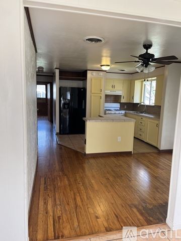 Kyle apartment for rent - A kitchen with wooden floors and a ceiling fan.
