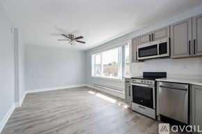 Chicago apartment for rent - A kitchen with a fan on the ceiling and a window letting in light.