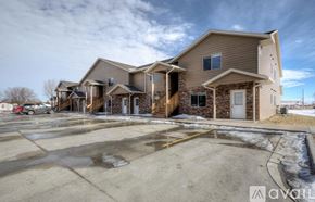 Rapid City apartment for rent - A large house with a parking lot in front.