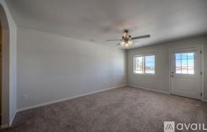 Rapid City apartment for rent - A room with a carpeted floor and a ceiling fan.