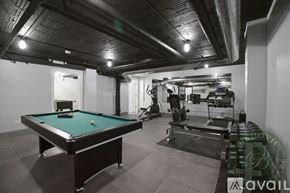 Chicago apartment for rent - A pool table is in the middle of a room with exercise equipment.